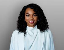 Dr. Linda wearing a white blazer and shirt smiling
